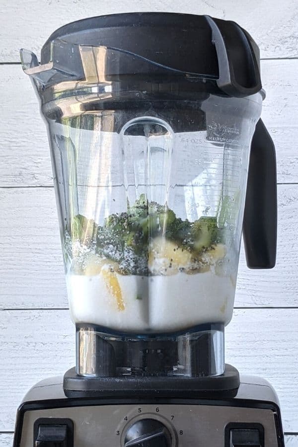 blender with all ingredients for the broccoli smoothie