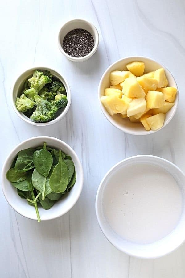 easy ingredients of the broccoli smoothie with pineapple, chia seeds, broccoli, spinach, and coconut milk