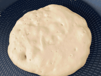 Fluffy vegan protein pancake instruction image 4: bubbles on pancake when it is ready to flip