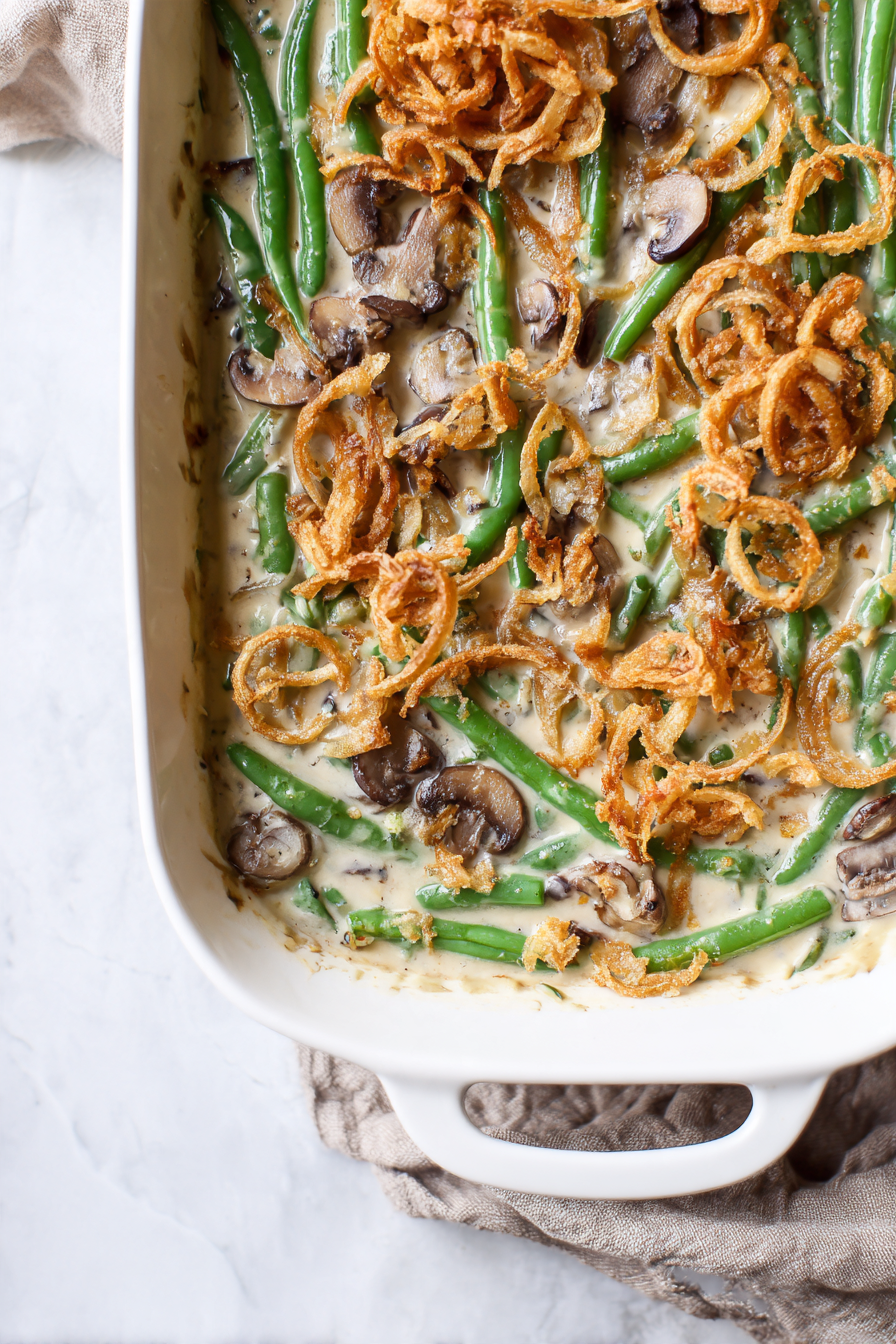 Creamy vegan green bean casserole topped with crispy onions and mushrooms