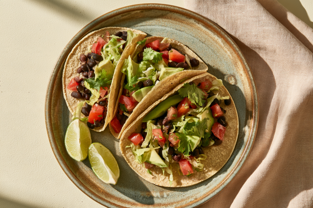 Black bean tacos with avocado, tomatoes, cilantro, and lime